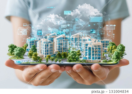 Close-Up of Hands Holding a Holographic Projection of a Modern Cityscape Model 131004834