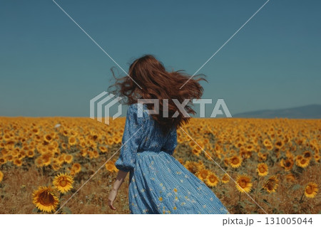 Person Running Through Bright Sunflower Field on a Midday Sun Person Running Through Bright Sunflower Field on a Midday Sun 131005044