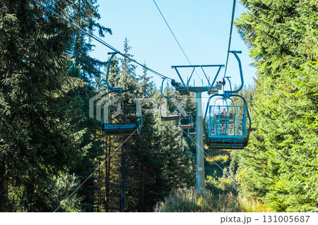 Chair Lift above the mountains and green forest of Bulgaria. Eco tourism. Tourist attraction. Seven Rila lakes. Cable car in the Rila Mountains 131005687