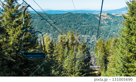Chair Lift above the mountains and green forest of Bulgaria. Eco tourism. Tourist attraction. Seven Rila lakes. Cable car in the Rila Mountains 131005690