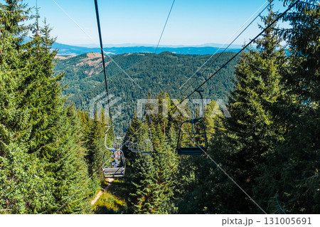 Chair Lift above the mountains and green forest of Bulgaria. Eco tourism. Tourist attraction. Seven Rila lakes. Cable car in the Rila Mountains 131005691