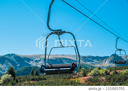 Chair Lift above the mountains and green forest of Bulgaria. Eco tourism. Tourist attraction. Seven Rila lakes. Cable car in the Rila Mountains 131005701
