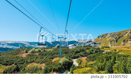 Chair Lift above the mountains and green forest of Bulgaria. Eco tourism. Tourist attraction. Seven Rila lakes. Cable car in the Rila Mountains 131005702