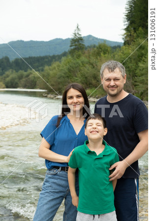Happy family mom, dad and child walking in nature Happy family mom, dad and child walking in nature 131006191