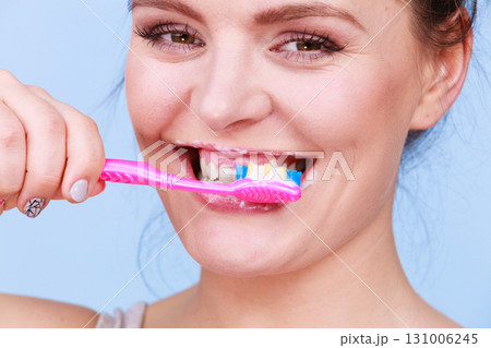 Woman brushing cleaning teeth Woman brushing cleaning teeth 131006245