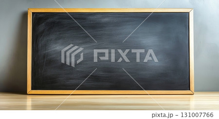 Smooth black surface of a chalkboard framed in wood, ideal for teaching or presentations, located in a classroom environment 131007766