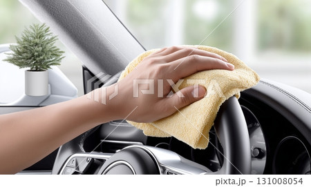 Cleaning a car interior with a microfiber cloth in a bright space Cleaning a car interior with a microfiber cloth in a bright space 131008054