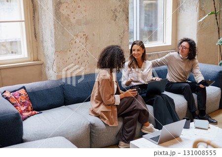 Engaging in a Collaborative Team Discussion within a Stylish and Modern Workspace Environment Engaging in a Collaborative Team Discussion within a Stylish and Modern Workspace Environment 131008555
