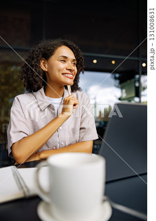 Focused Young Woman at Caf with Laptop and Coffee 131008631