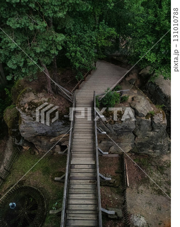 Wooden footbridge crossing scenic rock formation in kokorin, czechia Wooden footbridge crossing scenic rock formation in kokorin, czechia 131010788