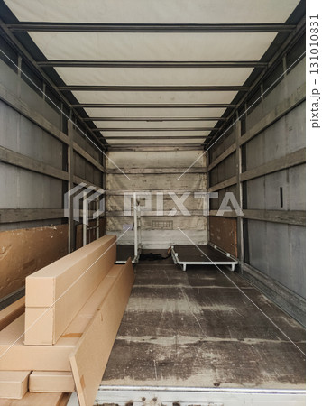 Cardboard boxes and furniture parts waiting for delivery in truck trailer 131010831