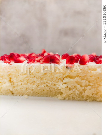 Delicious slice of semolina cake with white frosting and pomegranate seeds copy space Delicious slice of semolina cake with white frosting and pomegranate seeds copy space 131010860