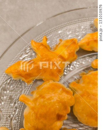 Halloween bat cookies resting on elegant glass platter Halloween bat cookies resting on elegant glass platter 131010976