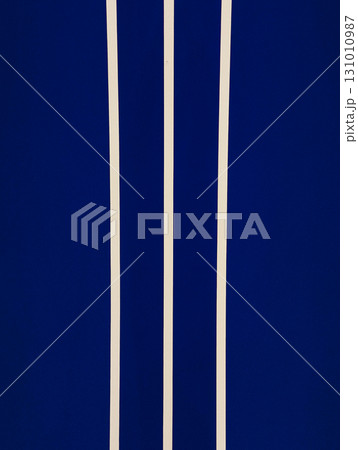 Three vertical beige stripes on dark blue background creating modern and minimalist pattern Three vertical beige stripes on dark blue background creating modern and minimalist pattern 131010987