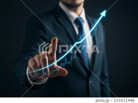 Businessman pointing at upward trend graph 131011446