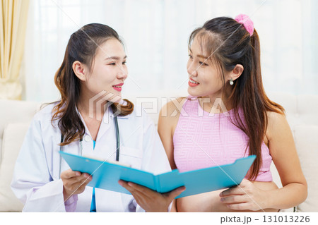 An Asian pregnant woman have an monthly health check with a doctor in hospital to check about her pregnancy. A health care and wellbeing in pregnant woman. An Asian pregnant woman have an monthly health check with a doctor in hospital to check about her pregnancy. A health care and wellbeing in pregnant woman. 131013226