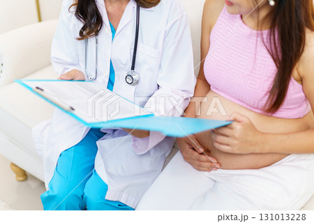 An Asian pregnant woman have an monthly health check with a doctor in hospital to check about her pregnancy. A health care and wellbeing in pregnant woman. 131013228