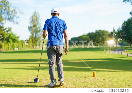 Asian male amateur golfer is enjoy playing golf at golf course in morning, he is showing his beautiful swing during tee off. Man playing golf. 131013286