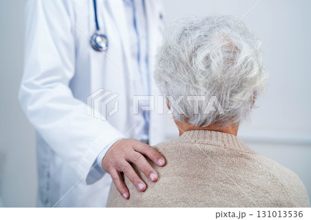 Doctor taking care, help and encourage Asian elder senior woman patient in clinic hospital. Doctor taking care, help and encourage Asian elder senior woman patient in clinic hospital. 131013536