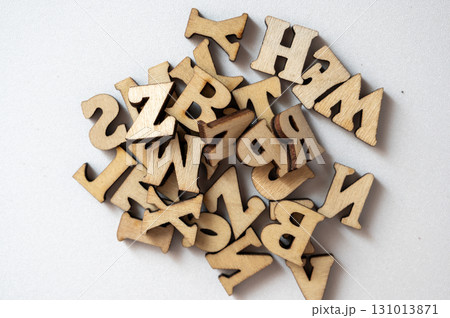 Wooden Alphabet Letters in a Random Pile on a Light Background 131013871