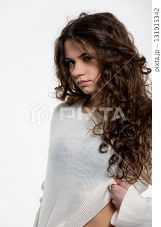 A Young Woman Who is Fashionable and Beautifully Dressed in a Cozy Knit Sweater Outfit A Young Woman Who is Fashionable and Beautifully Dressed in a Cozy Knit Sweater Outfit 131015342