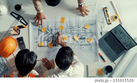 Top view of professional engineer team walking at meeting table. Alimentation. Top view of professional engineer team walking at meeting table. Alimentation. 131015520