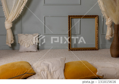 An Elegant and Cozy Interior Space Featuring a Decorative Frame Alongside Cushions 131015616