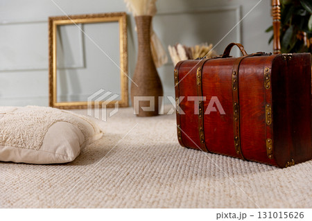 A vintage travel suitcase combined with cozy decor creates an inviting stylish setting 131015626
