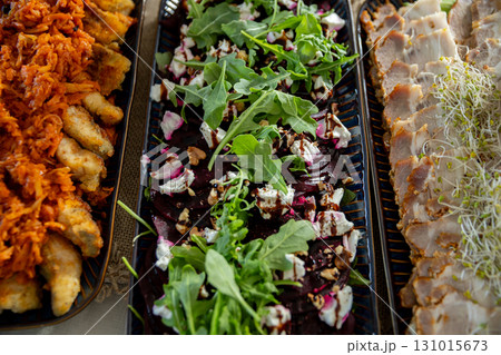 Indulge in a Gourmet Platter filled with an array of delicious Appetizers and fresh Salads 131015673