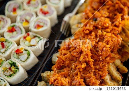 Enjoy a flavorful Asian cuisine platter with rolls and spicy topping, perfect for any occasion 131015688