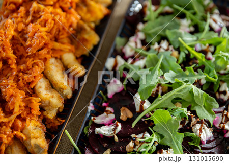 Enjoy a delicious platter of savory meats paired with a fresh, vibrant salad bursting with flavor 131015690