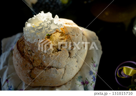 Delicious Artisan Bread Featuring an Exquisite Decorative Topping Resting on a Floral Napkin 131015710