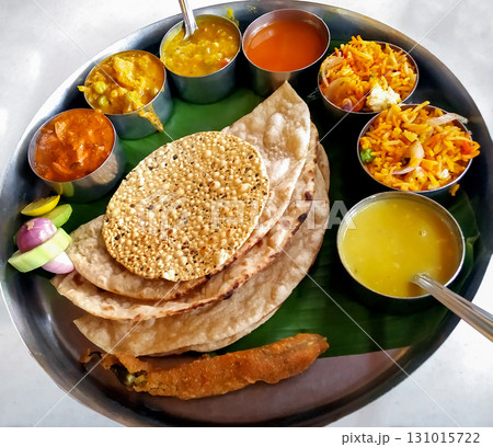 Traditional Indian Thali with Roti, Rice, Curries, and Papad 131015722