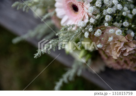 A Delicate Flower Bouquet Displaying Soft and Gentle Colors Alongside Lush Greenery A Delicate Flower Bouquet Displaying Soft and Gentle Colors Alongside Lush Greenery 131015759