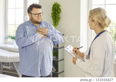 Overweight patient with chest discomfort consulting doctor at clinic appointment 131016827