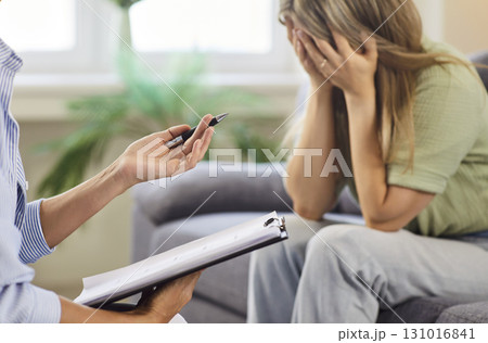 Psychologist supporting distressed patient during mental health counseling session 131016841