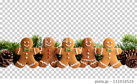 Decorated Christmas gingerbread cookies and pine cones on wooden table isolated on white background Decorated Christmas gingerbread cookies and pine cones on wooden table isolated on white background 131018528