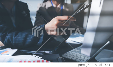 Close up high angle Asian businesswoman working with her coworker in meeting room 131019384