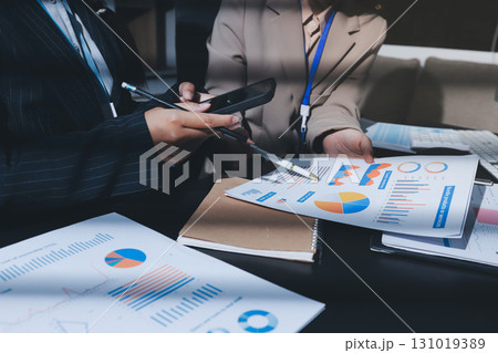 Close up high angle Asian businesswoman working with her coworker in meeting room Close up high angle Asian businesswoman working with her coworker in meeting room 131019389