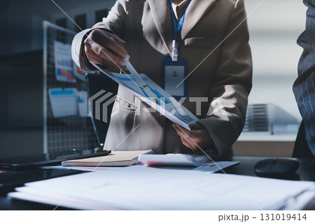 Close up high angle Asian businesswoman working with her coworker in meeting room Close up high angle Asian businesswoman working with her coworker in meeting room 131019414