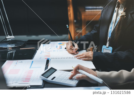 Close up high angle Asian businesswoman working with her coworker in meeting room Close up high angle Asian businesswoman working with her coworker in meeting room 131021586
