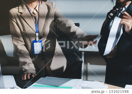 Close up high angle Asian businesswoman working with her coworker in meeting room Close up high angle Asian businesswoman working with her coworker in meeting room 131021598