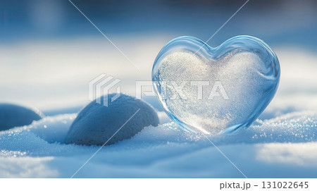 Transparent glass heart sculpture snow winter scene frozen crystal clear ice formation cold weather seasonal decoration romantic symbol 131022645