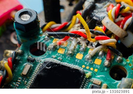A close-up macro shot of the flight controller of a self-assembled drone built on a carbon fiber frame with exposed electronics. A close-up macro shot of the flight controller of a self-assembled drone built on a carbon fiber frame with exposed electronics. 131023891