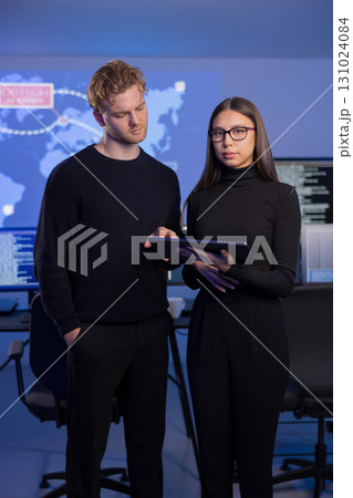 Professional analysts investigate cybersecurity incidents in advanced control room environment 131024084