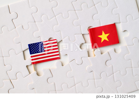 United States and Vietnam flags on puzzle pieces, symbol of partnership, cooperation, and international relations 131025409