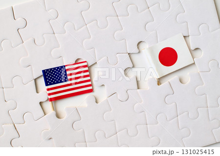 United States and Japan flags on puzzle pieces, symbol of partnership, cooperation, and international relations United States and Japan flags on puzzle pieces, symbol of partnership, cooperation, and international relations 131025415