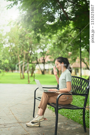 Young woman worker using laptop in the park, Digital nomad concept Young woman worker using laptop in the park, Digital nomad concept 131025807