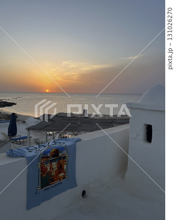 Sunset view from a white house in Djerba, Tunisia with a free Palestine t-shirt hanging on the wall Sunset view from a white house in Djerba, Tunisia with a free Palestine t-shirt hanging on the wall 131026270