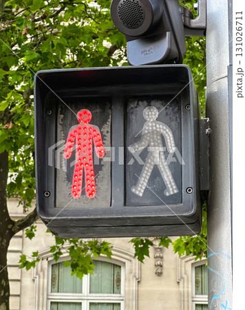 A close-up shot of a traffic light for pedestrians, with the red don't walk signal illuminated. 131026711